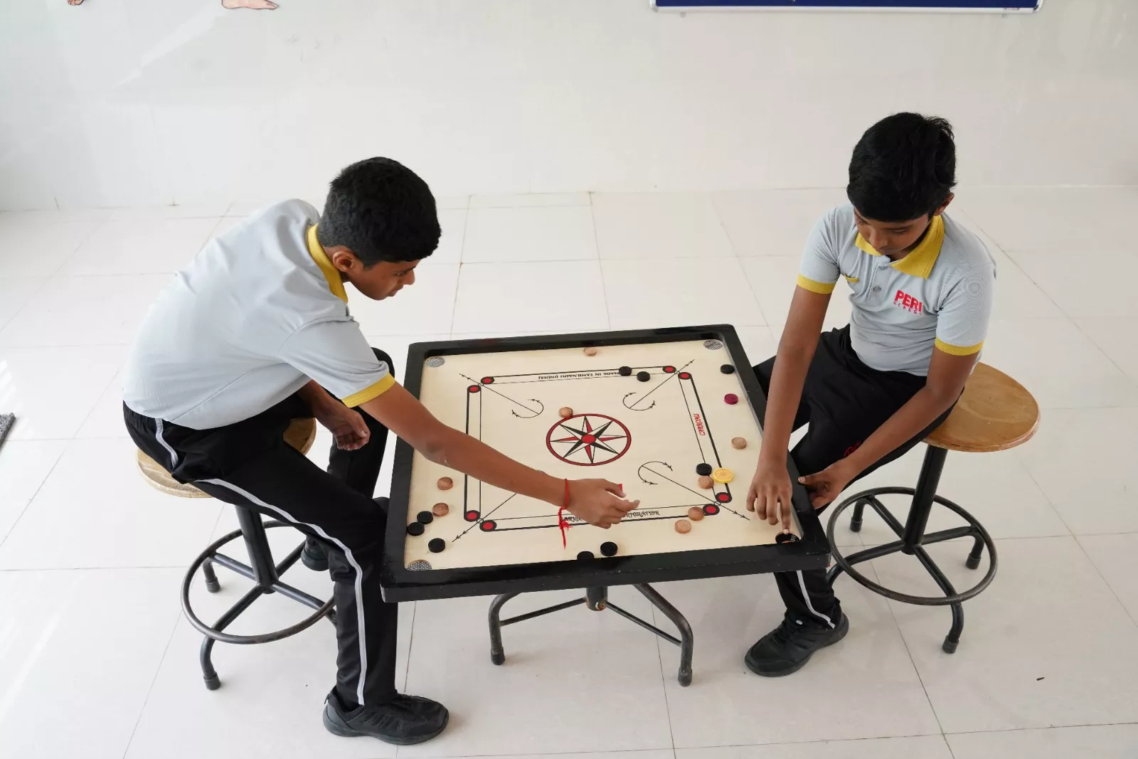 Playing Carrom in PERI School